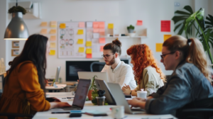 Team members in an office setting using project management tools and task boards for scheduled teamwork.