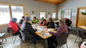 Volunteer management and engagement in non-profit organizations, showing volunteers collaborating on a community project under the guidance of a volunteer coordinator.