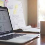 Professional workspace with a notepad showing examples of career goals.