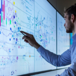 Project manager using charts for project cost estimating.